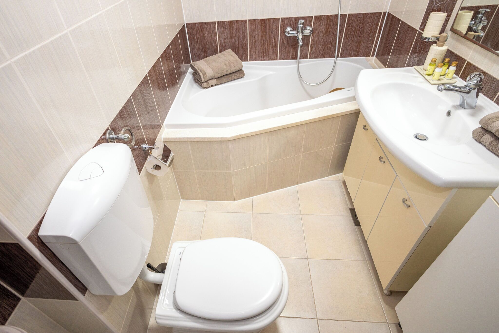 A bathroom with a toilet, a sink, a bathtub, and a shower.