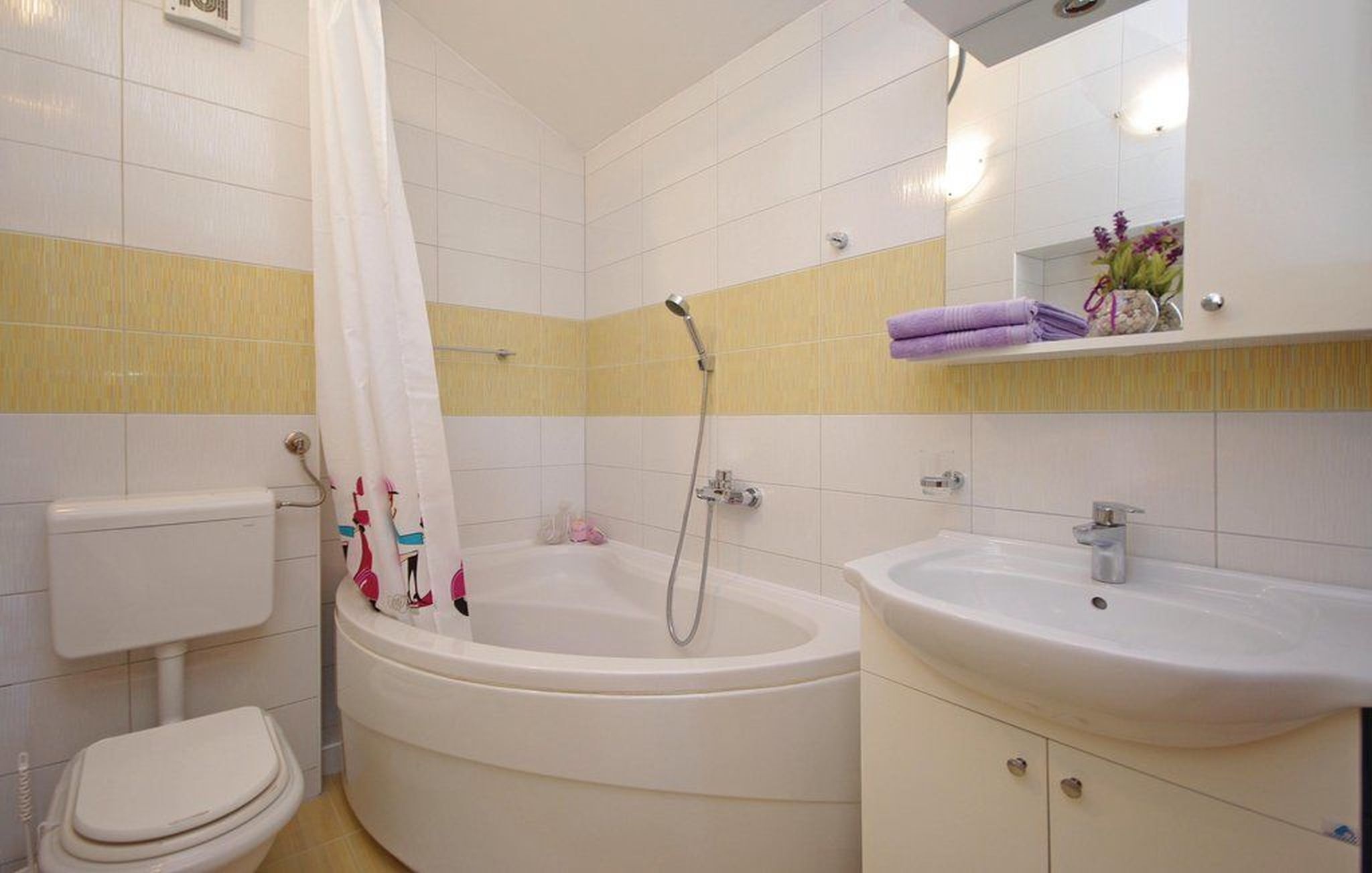 A bathroom with a toilet, a bathtub, and a sink.