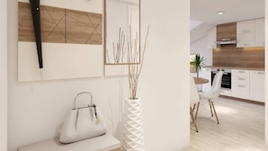 A modern kitchen with white cabinets, a wooden countertop, and a built-in oven. - Apartments Villa Subic (Kampor)