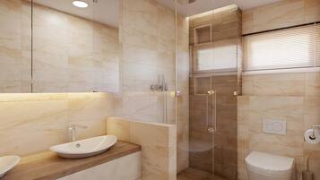 Un baño moderno con tocador de madera, ducha con cerramiento de vidrio y un inodoro.