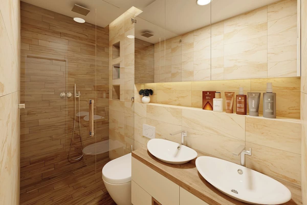A modern bathroom with a glass-enclosed shower, two sinks, and a vanity with toiletries.