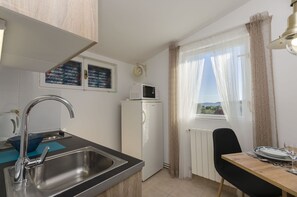 Private kitchen | Fridge, microwave, stovetop, espresso maker - Apartments Sunset Beach (Vodice)