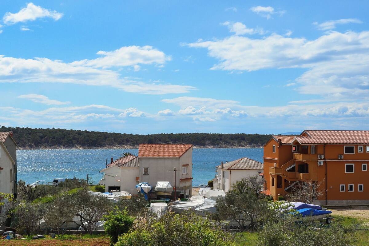 A coastal residential area with houses and a view of the sea.
