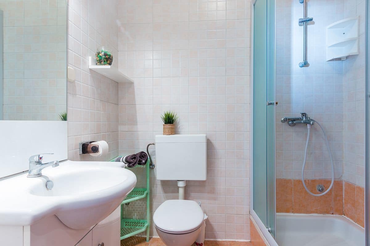 A bathroom with a sink, toilet, and shower.