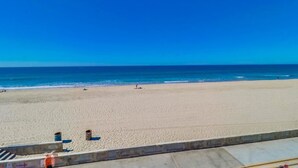 A beach with a clear sky and calm sea. - Ocean Front House with Private Ground Level Patio & 2 Garages - Sleeps 10+ (San Diego)