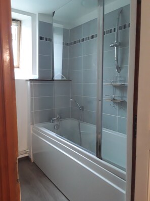 Bathtub, hair dryer, towels, soap