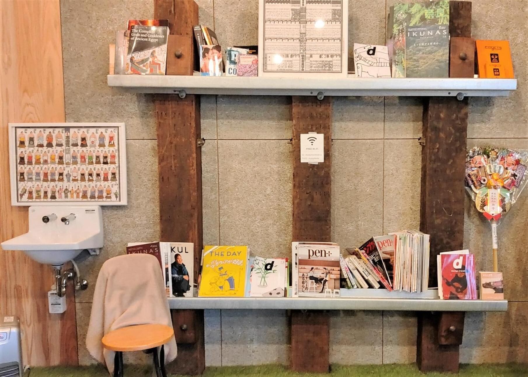 A bookstore with wooden shelves, a sink, and a chair.