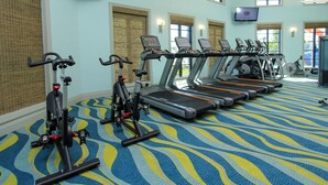 A gym with treadmills, stationary bikes, and an elliptical machine. - Champions Gate 1433ww (Davenport)