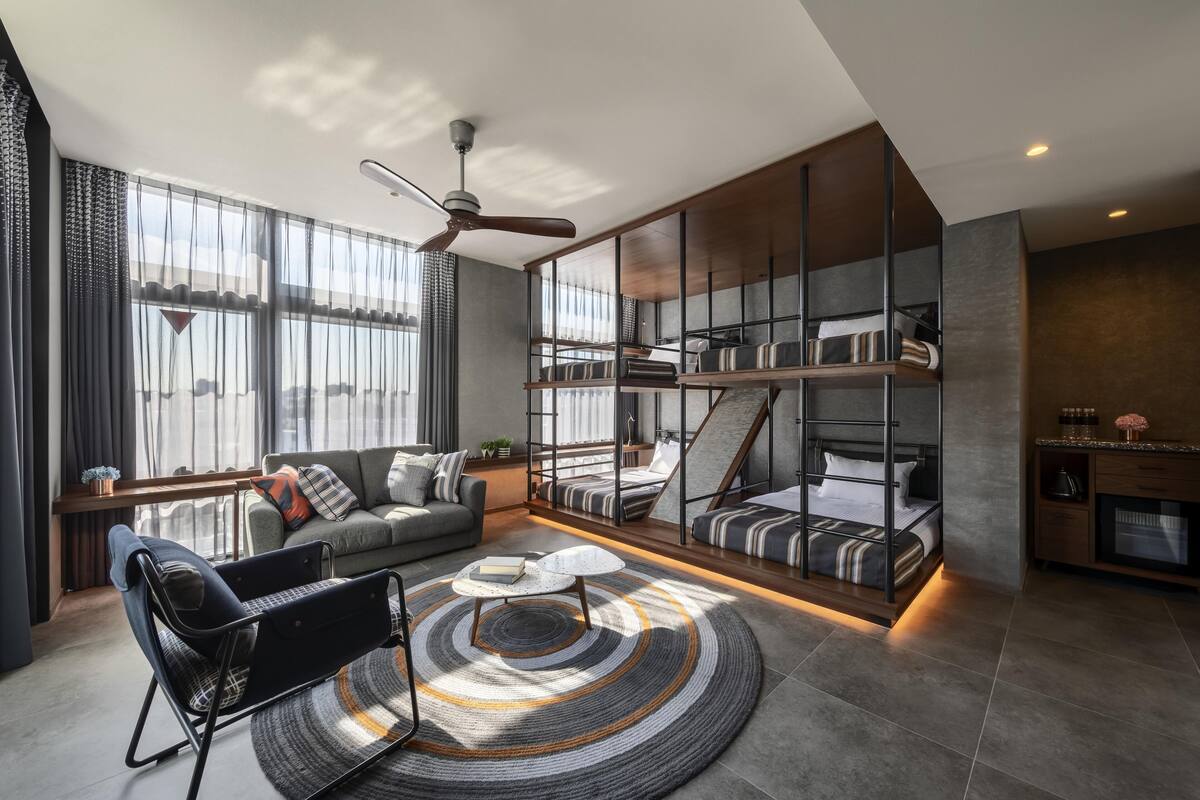 A modern living room with a sofa, a coffee table, and a bookshelf.
