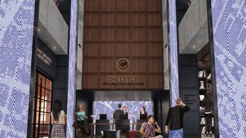 A modern building with a large wooden panel and illuminated patterns on the walls.