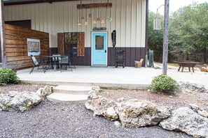 Guests can relax in the welcoming outdoor space with a table and chairs.
