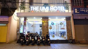 A multi-story hotel with balconies and potted plants. The hotel's name, "The Umi Hotel," is displayed on the facade. - The Umi Hotel (Ho Chi Minh City)