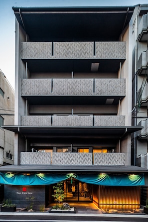 Mayu Grace Hotel features a modern architectural design with a flat roof and patterned balconies.