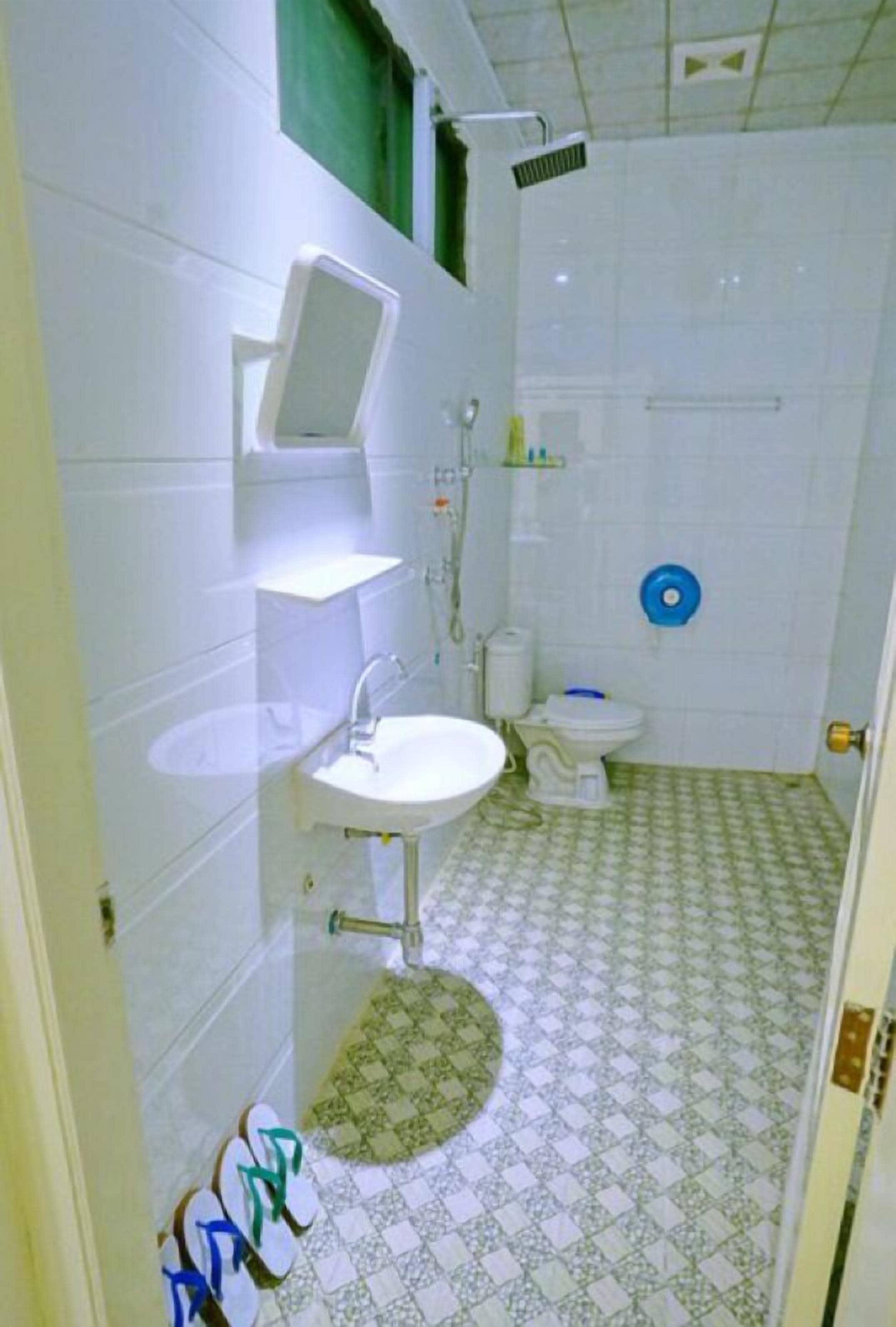 A bathroom with a sink, toilet, and shower.