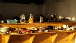 A breakfast bar with various food items and kitchen appliances. - Mandalay Hill View Inn (Mandalay)