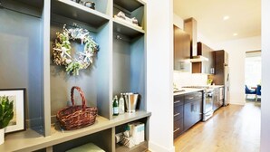 A modern kitchen with built-in appliances and a dining area. - Close to Broadway · Rooftop Skyline · Walkable (Nashville)