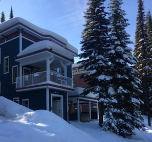 Stunning two-story building with a spacious balcony and traditional facade, featuring a welcoming entrance and porch.