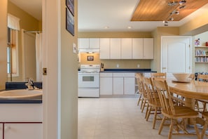 Enjoy meals at the dining table, surrounded by ample counter space and a central island.