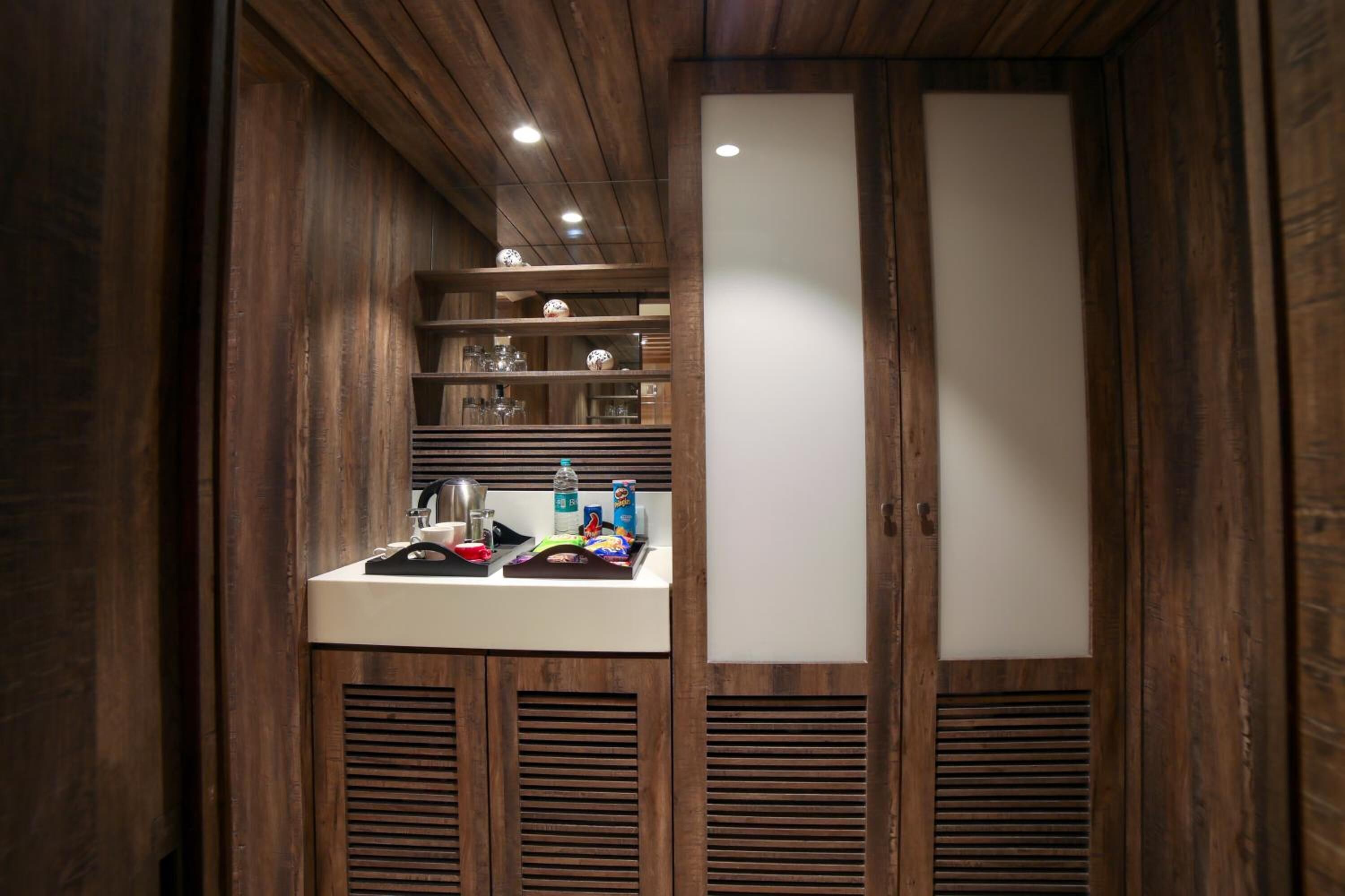 A bathroom with wooden paneling, a white sink, and shelves with toiletries.