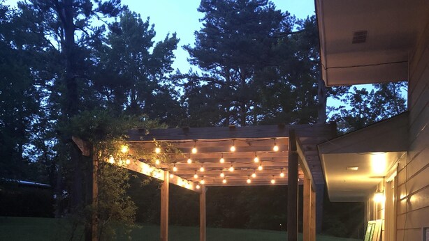 A covered patio area with string lights, a concrete floor, and a wooden pergola. - Quiet Home less than a mile from Vaught Hemingway (Oxford)