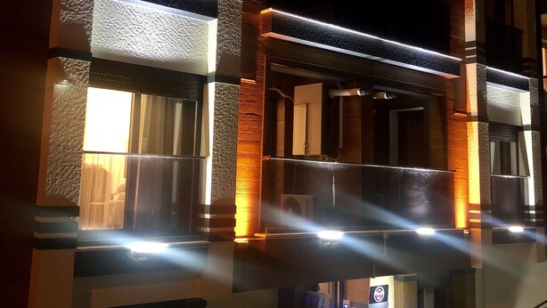 A multi-story building with a modern architectural design, featuring prominent columns and a balcony. - Beta Homes Boutique Hotel (Izmir)