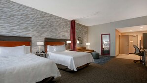 A hotel room with two beds, a desk, a chair, a lamp, and a bathroom door. - Home2 Suites by Hilton Charlotte Northlake (Charlotte)
