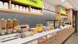 A breakfast buffet with labeled containers of food, a coffee machine, and a sign that says "inspired table". - Home2 Suites by Hilton Harrisburg North (Harrisburg)