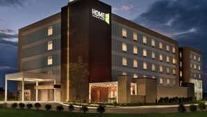 A modern hotel building with a prominent 'HOME 2' sign, multiple floors, and a covered entrance area. - Home2 Suites by Hilton Harrisburg North (Harrisburg)
