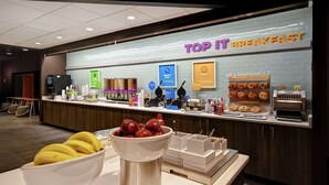 A breakfast area with a sign reading "TOP IT BREAKFAST" and various food items displayed. - Tru By Hilton Cincinnati Airport South Florence (Florence)