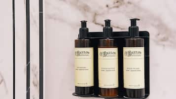 Three bottles of Bigelow Apothecaries products on a marble shelf.