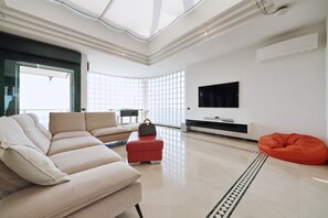 Exclusive Villa, 4 Bedrooms | Living area | Flat-screen TV, fireplace