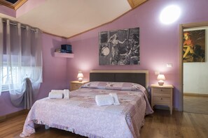Cozy retreat with a large bed, bedside tables, and a framed picture above.