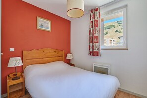Bedroom with a double bed and patterned curtains