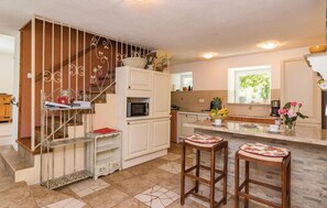 Fridge, stovetop, dishwasher, coffee/tea maker