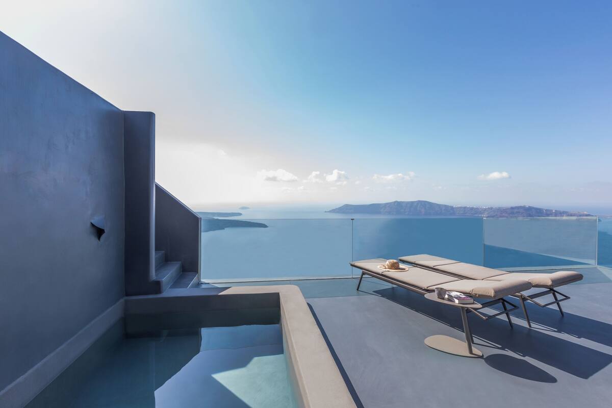 A modern balcony with a view of the sea and distant islands.
