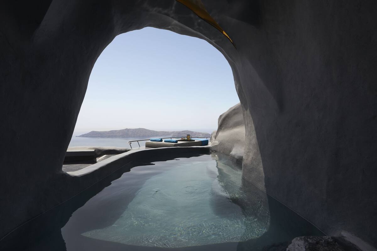 An infinity pool with a clear view of the sea and distant mountains.