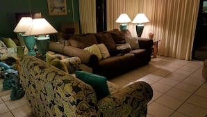 A living room with a sofa, patterned armchairs, and two lamps. - Right On the Beach !  Vacation Condo ! (Panama City Beach)
