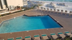 A swimming pool with lounge chairs and a beach view. - Right On the Beach !  Vacation Condo ! (Panama City Beach)