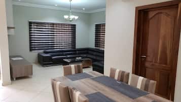 Deluxe Condo | Living area | Flat-screen TV