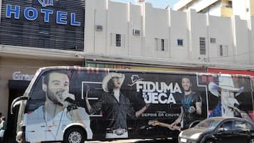 A bus with a large advertisement for a music tour.
