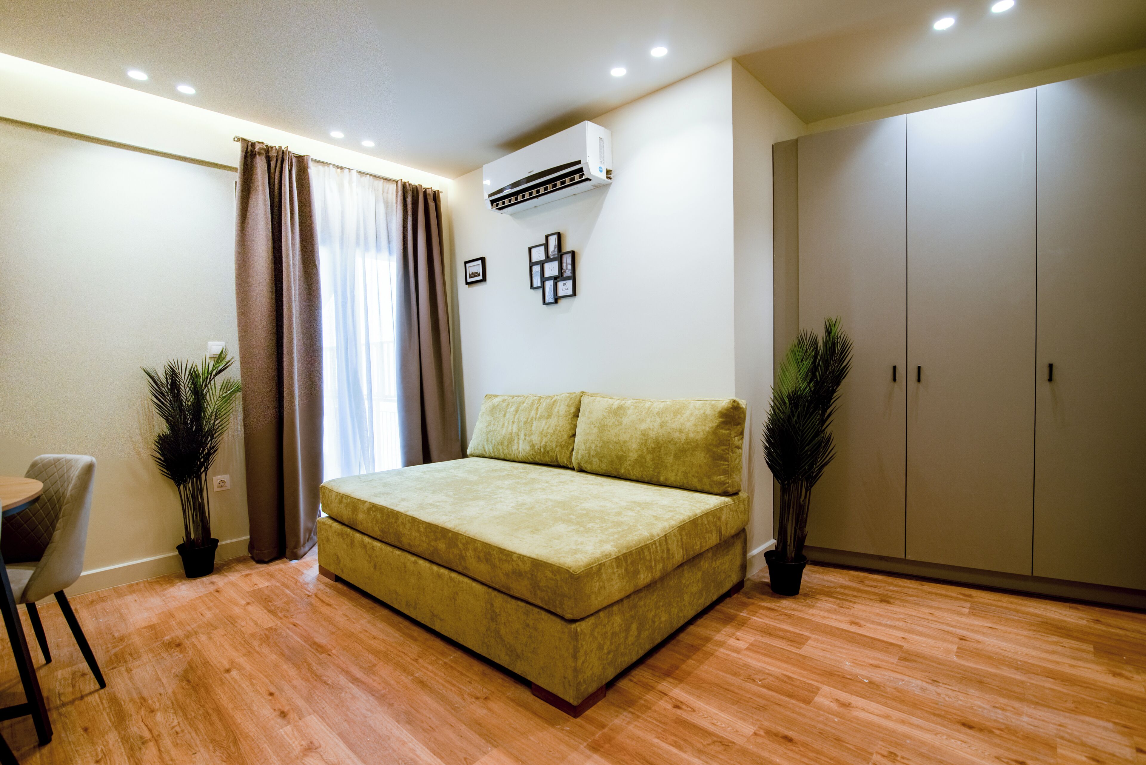 A room with a bed, a desk, and a wardrobe.