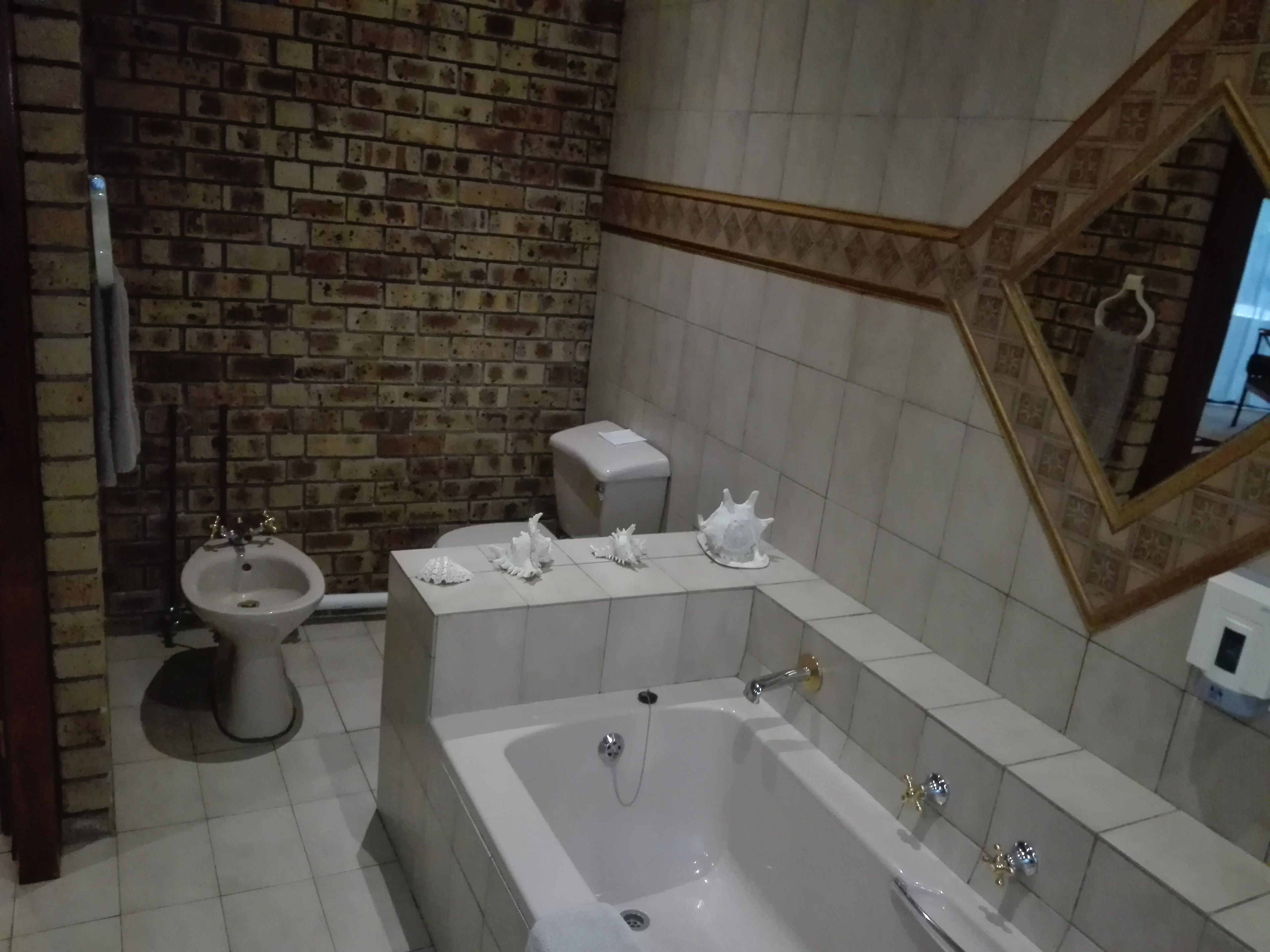 A bathroom with a bathtub, a bidet, and a toilet.