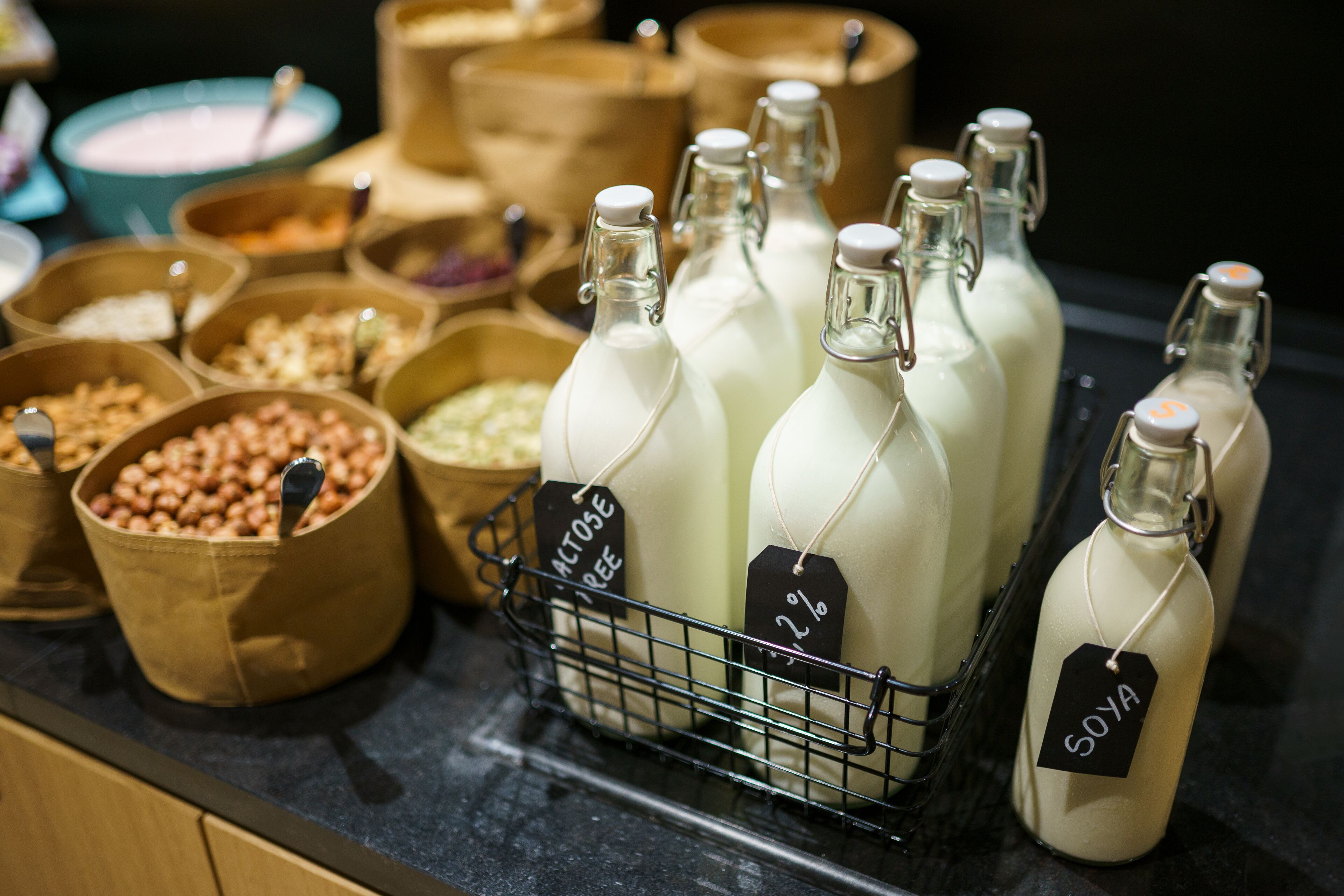 A variety of food items in containers, including jars labeled with 'SOYA' and 'ACTOSE FREE'.