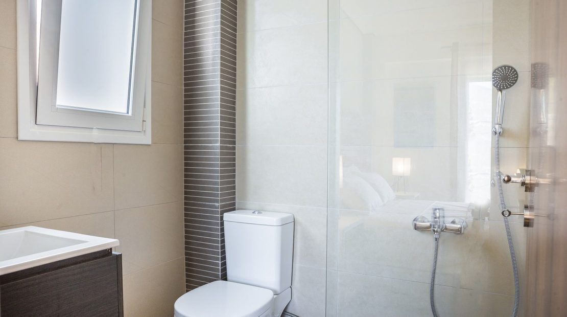 Ein modernes Badezimmer mit einer Duschkabine, einer Toilette und einem Waschbecken.