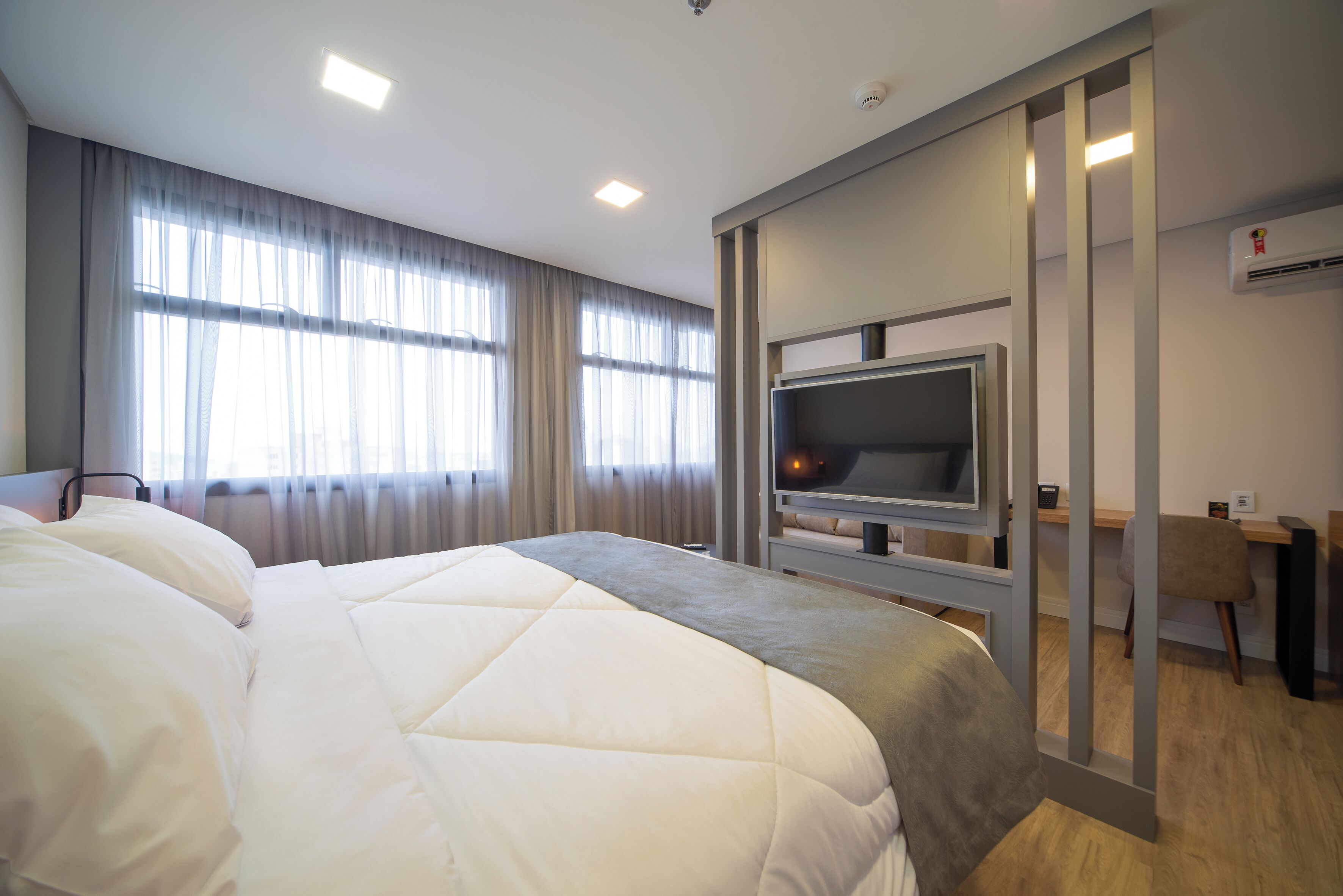 deluxe triple room | in-room safe, desk, laptop workspace, blackout curtains