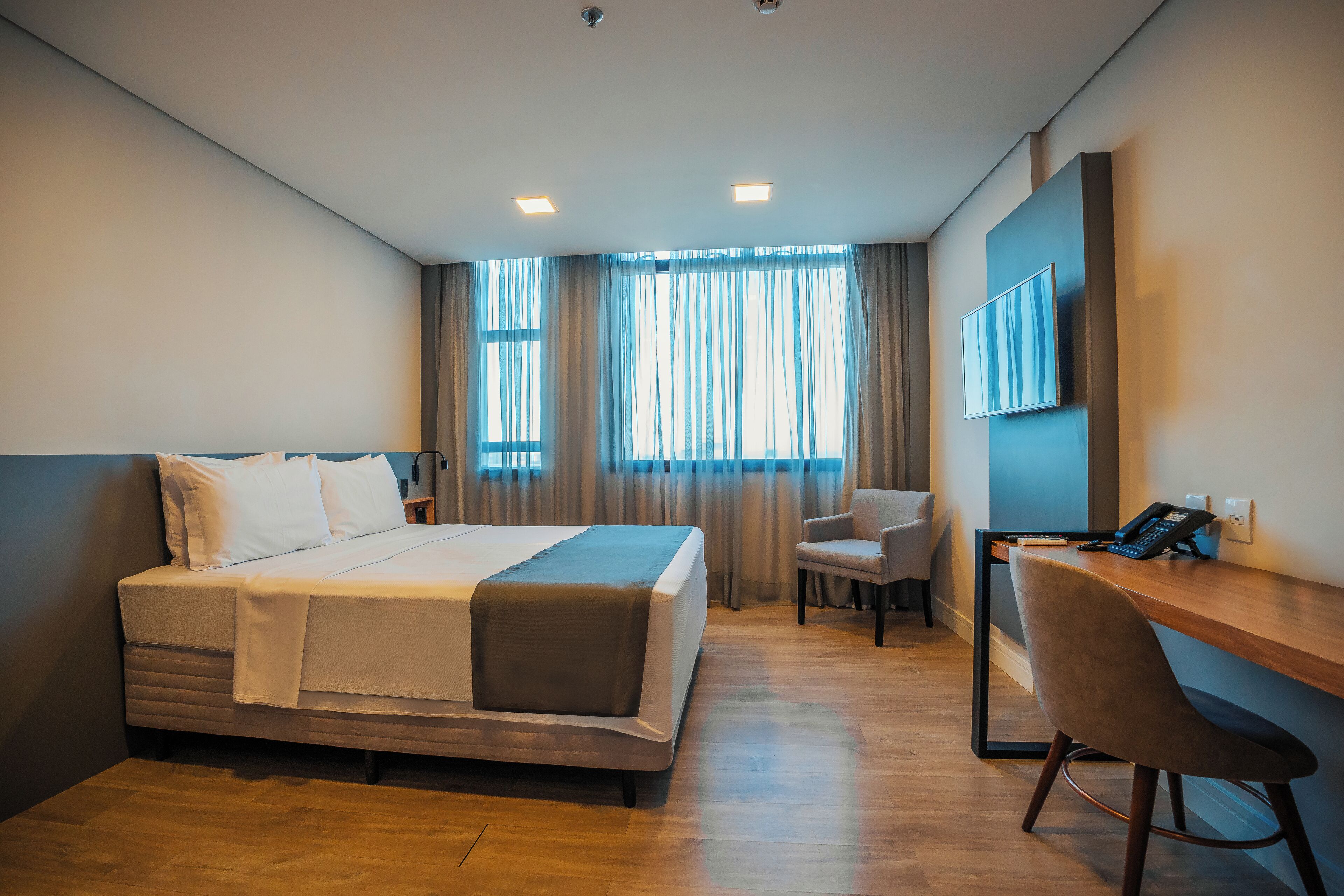 deluxe double room | in-room safe, desk, laptop workspace, blackout curtains