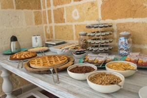 A buffet table with various food items including cakes, cookies, and cereals.