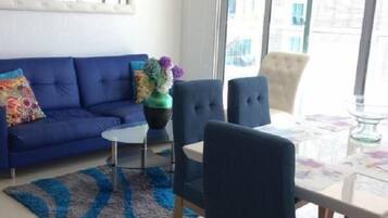 Apartment, 2 Bedrooms | Living room | 24-inch flat-screen TV with cable channels, TV