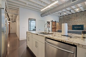 2 Bedroom | Private kitchen | Full-size fridge, microwave, stovetop, dishwasher - Roami at Motorworks (New Orleans)