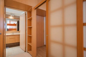A wooden interior with a bathroom and a closet.